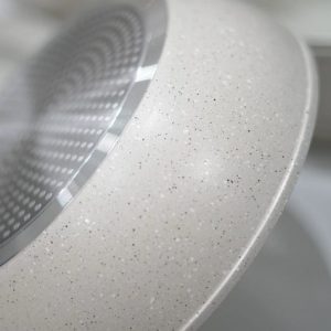 The stainless steel induction-compatible base plate visible on the bottom of a forged aluminum cooking pot.